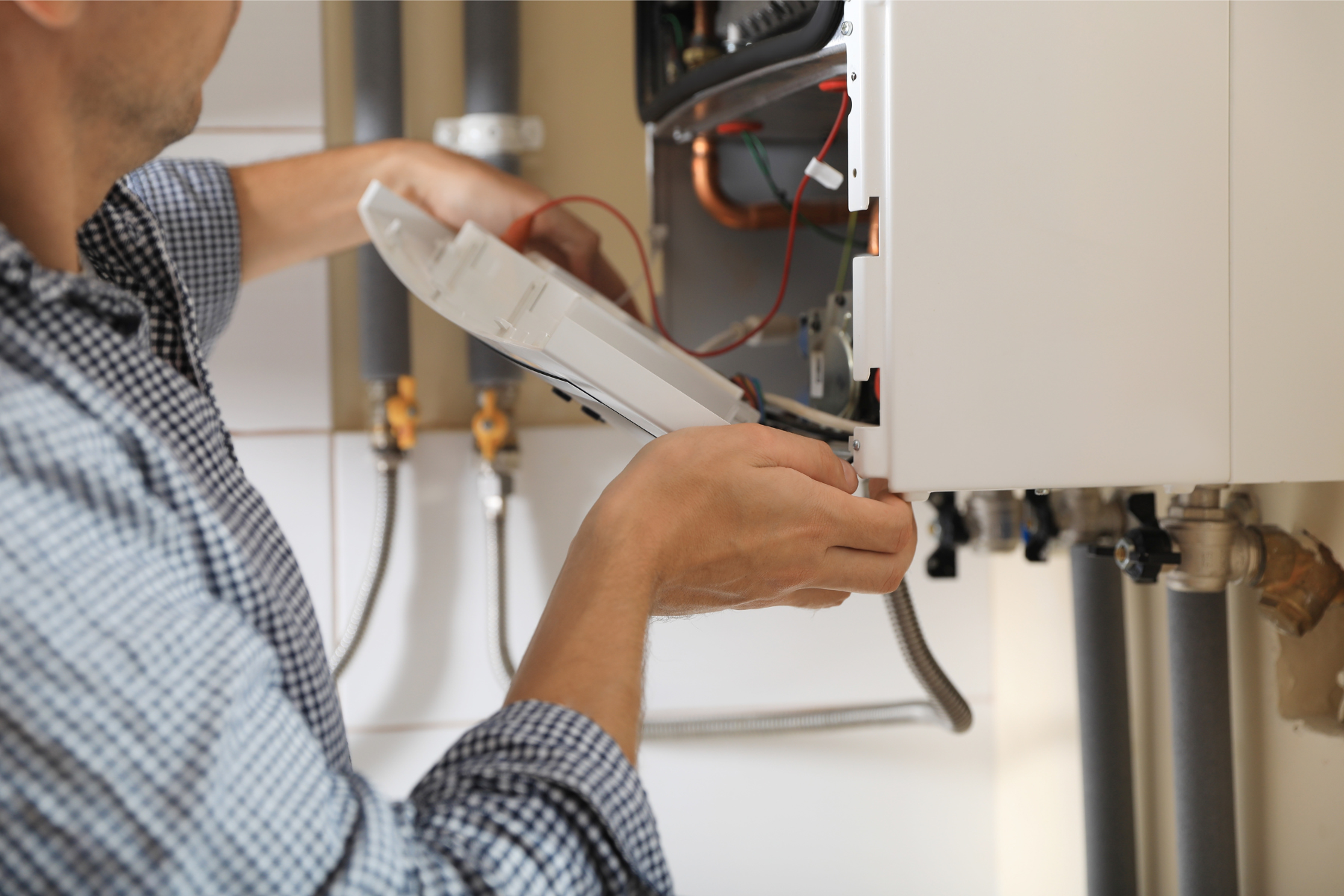 Engineer opening a boiler to diagnose a breakdown